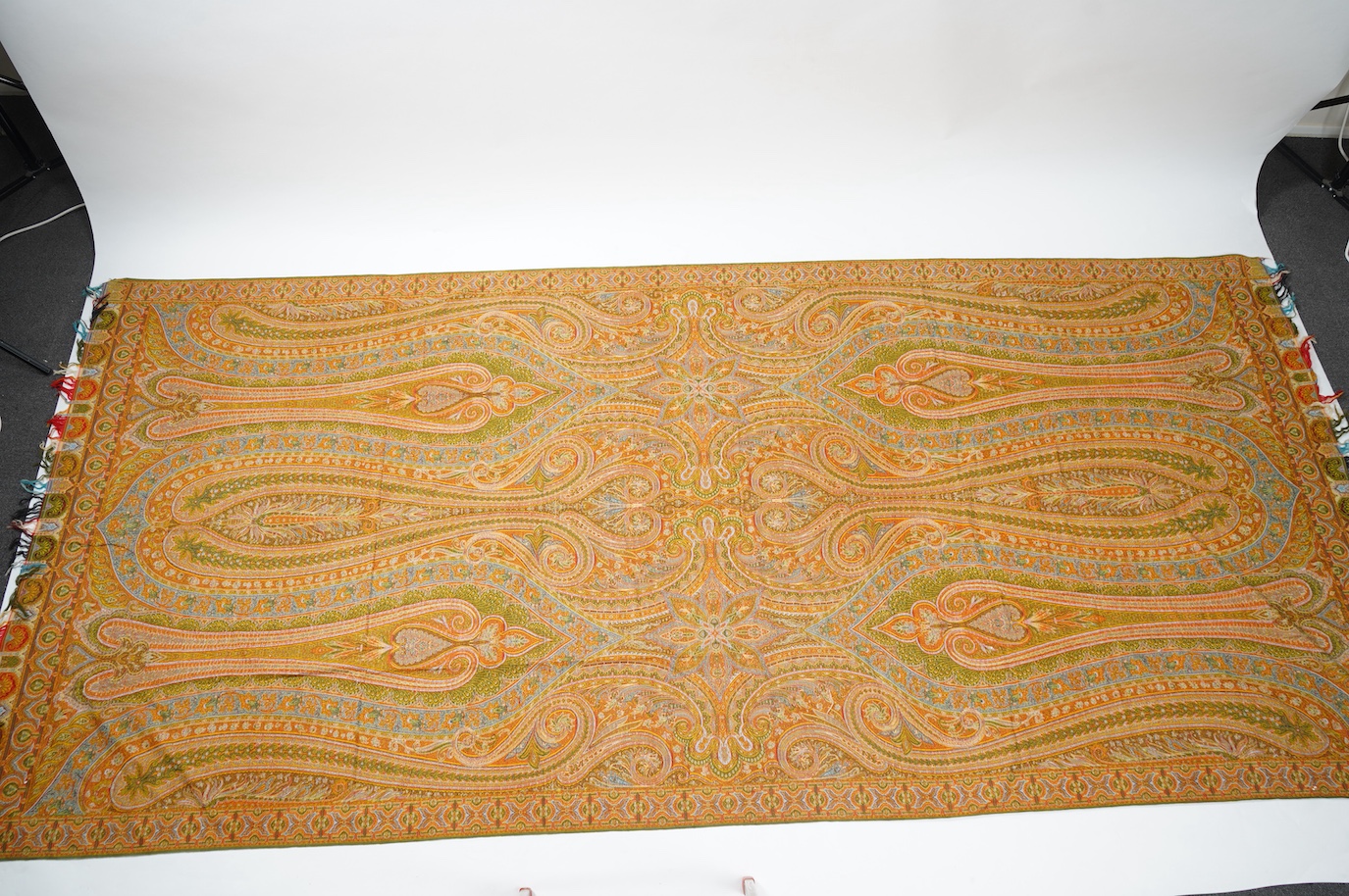 A French possibly Lyon, 19th century ornate silk and fine wool woven Paisley patterned shawl. Woven in polychromes coloured silks and wools on a jacquard loom, using an array of punch cards to create this elaborate desig